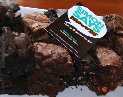 tray of dark and milk chocolate brownies with a business card